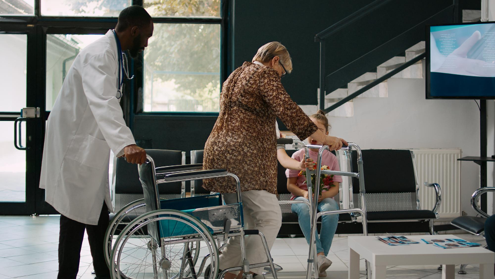 Patient being supported with a walking frame as part of a hospital prevention programme