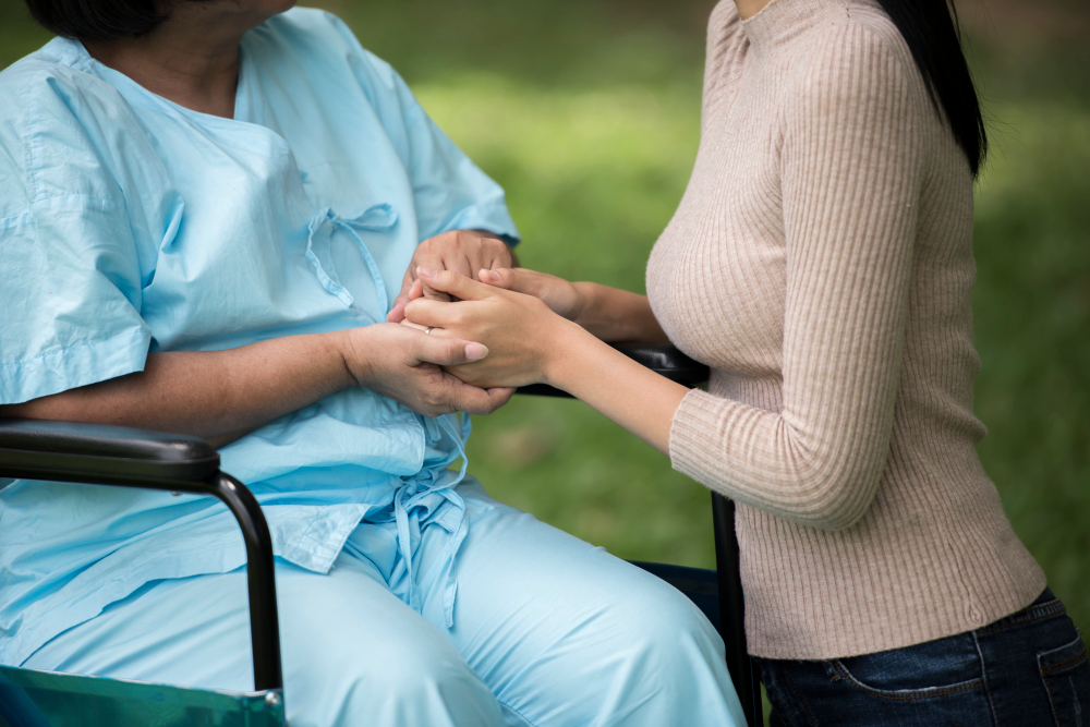 Compassionate nurse holding a palliative care patient hands offering comfort and dignity